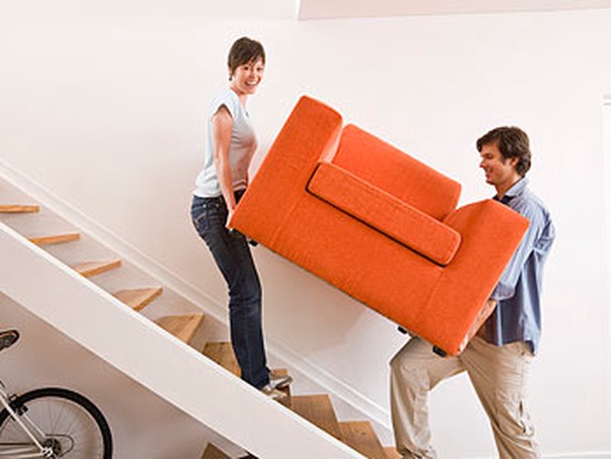 Couple carrying a couch