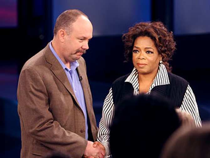 Oprah greets Flint Waters.