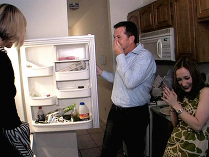 Peter Walsh opens a refrigerator with rotting food inside.