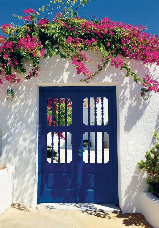 White wall and blue door in Greece