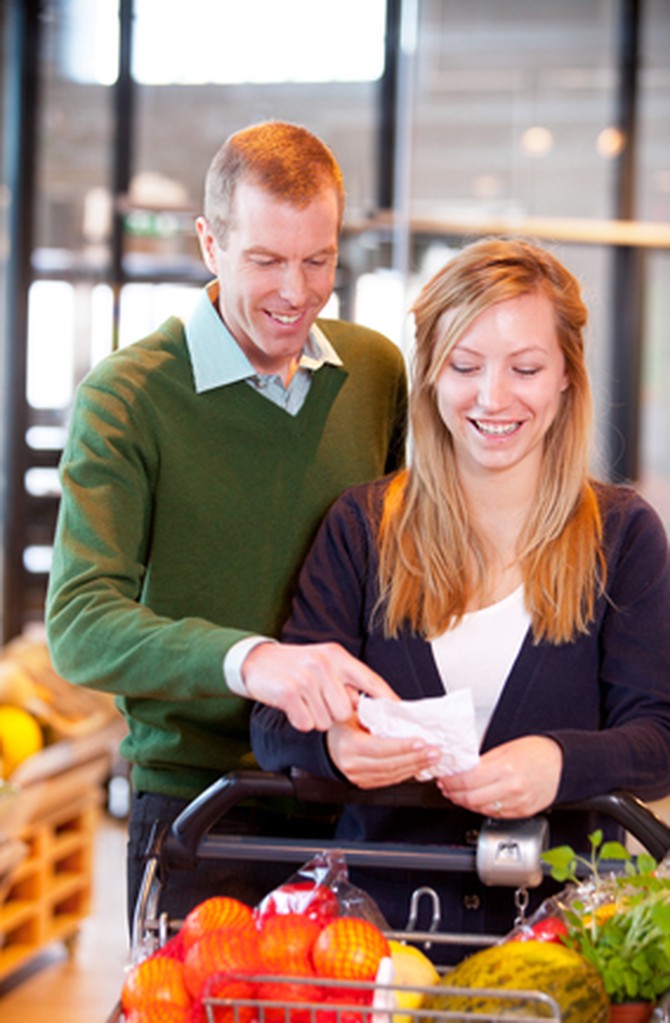 Couple looks at grocery list