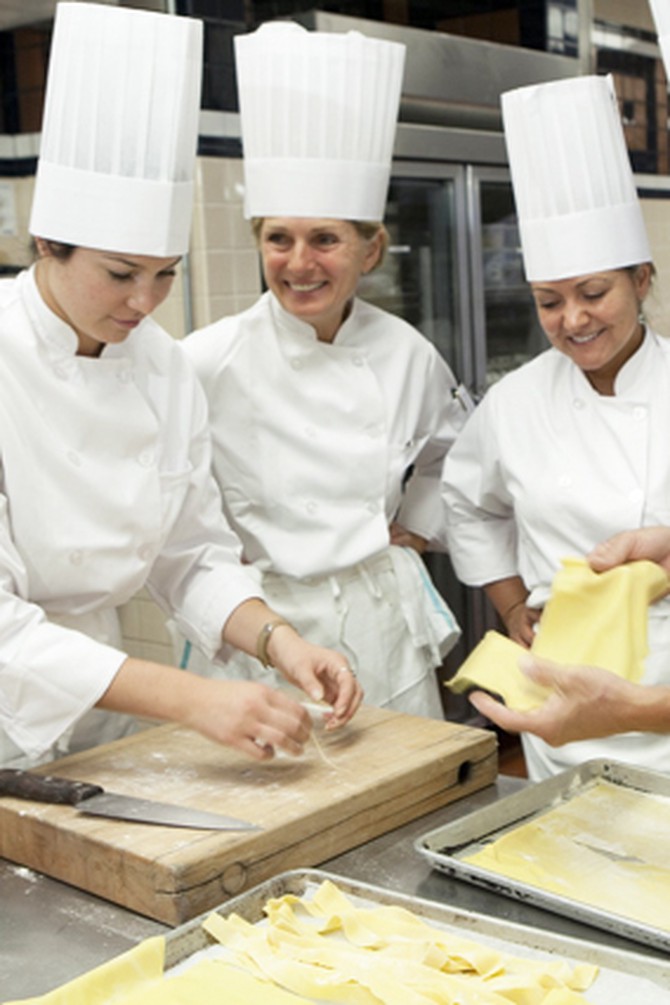 Cooking students making pasta