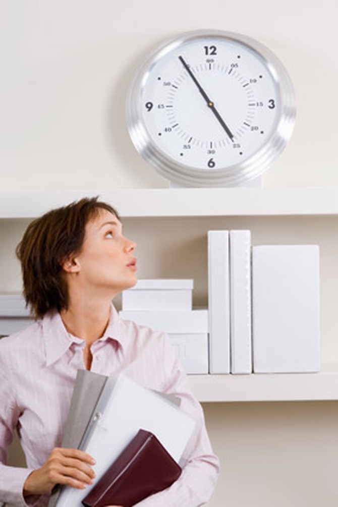 Woman running late and looking at the clock