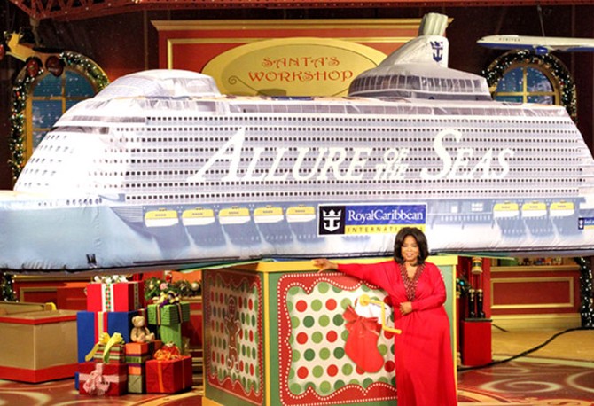 Oprah Winfrey in front of inflatable Allure of the Seas cruise ship
