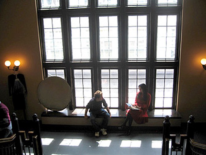 Angie Harmon and photographer sitting in front of windows