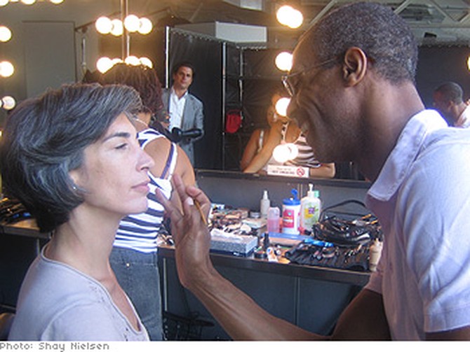 A model gets her makeup done.