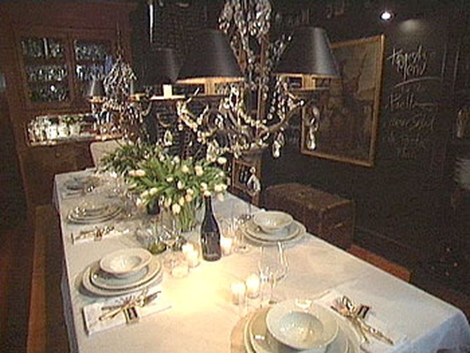 An elegant dinner table set in white china.