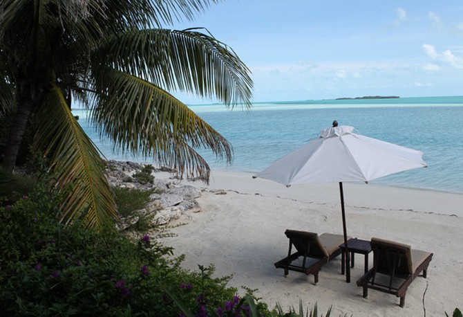 Beach chairs and umbrella on the beach of Musha Cay, David Copperfield's private island