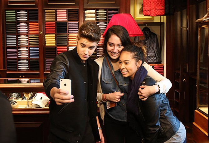 Justin Bieber takes a photo with fans