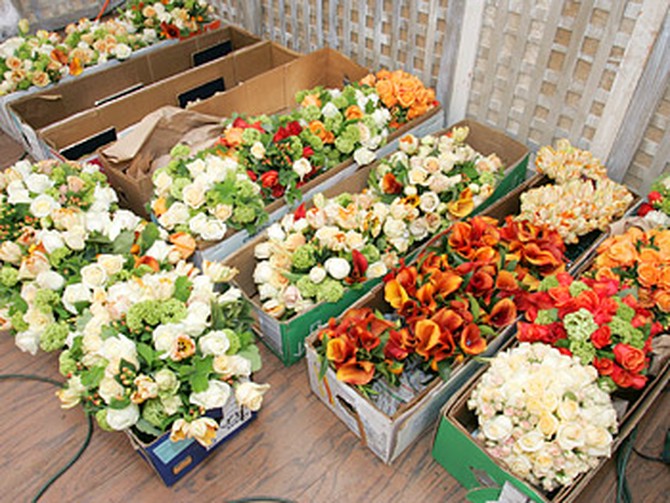 Hundreds of flowers for table centerpieces are delivered.