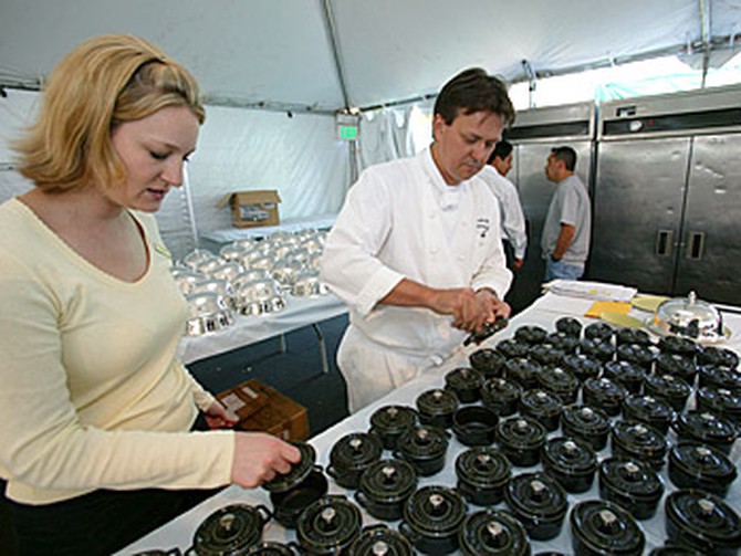 Chefs prepare individual soup tureens.