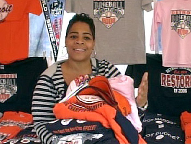 Sheril Hurt shows off sportswear donated to the homeless.