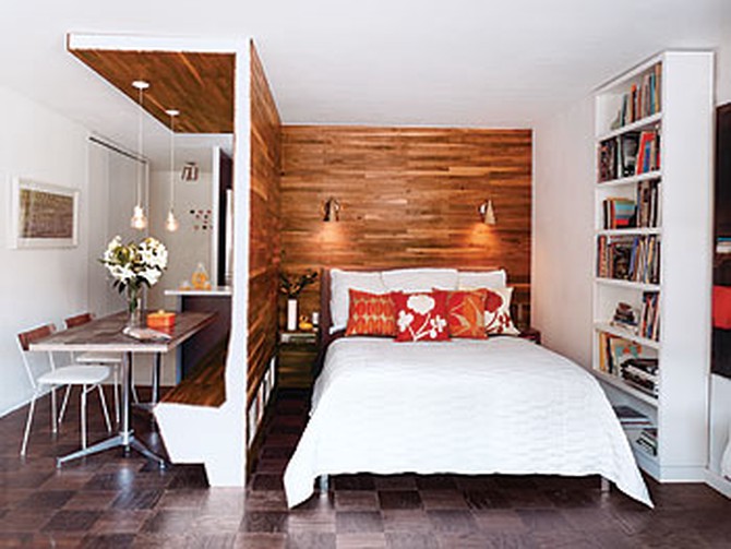 A walnut divider separates the bedroom from the dining room.