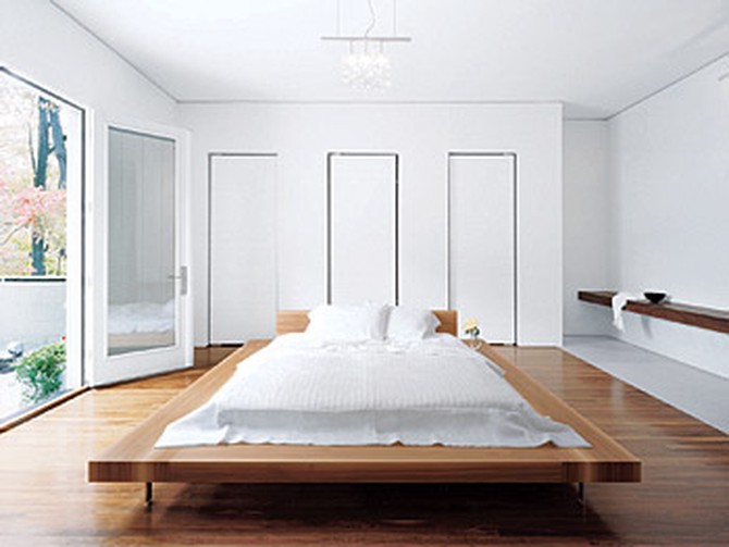 A walnut bed by Cappellini floats in the master bedroom.