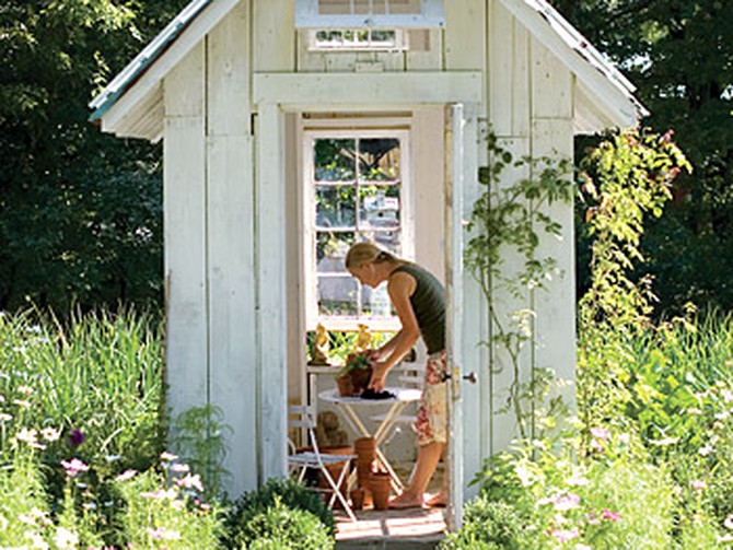 Amy works on gardening projects in the small potting shed that Paul built.