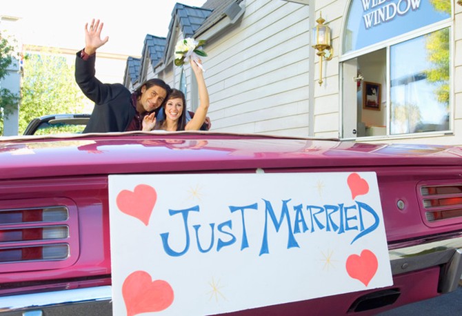 Couple in Just Married car