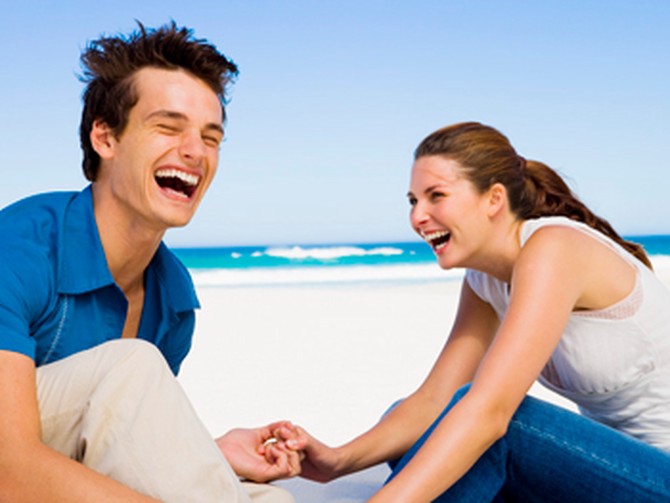 Couple laughing on beach