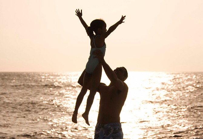 Father lifting up daughter
