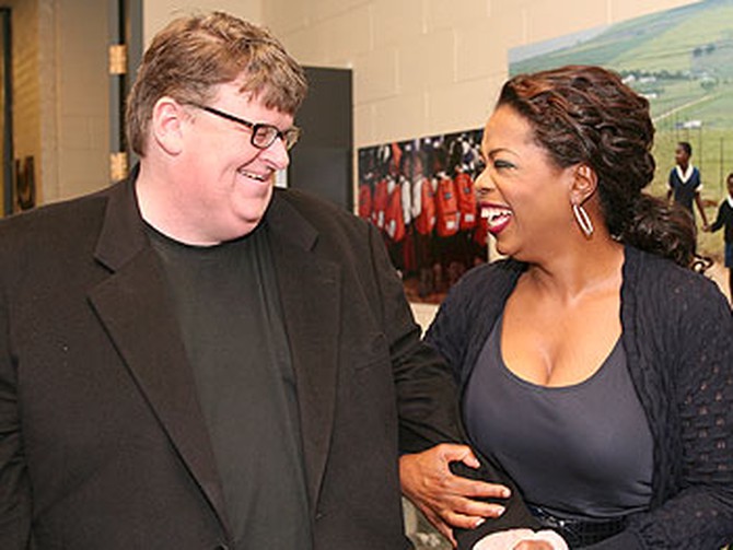 Oprah shares a laugh with 'Sicko' director Michael Moore in the hallway outside the studio.