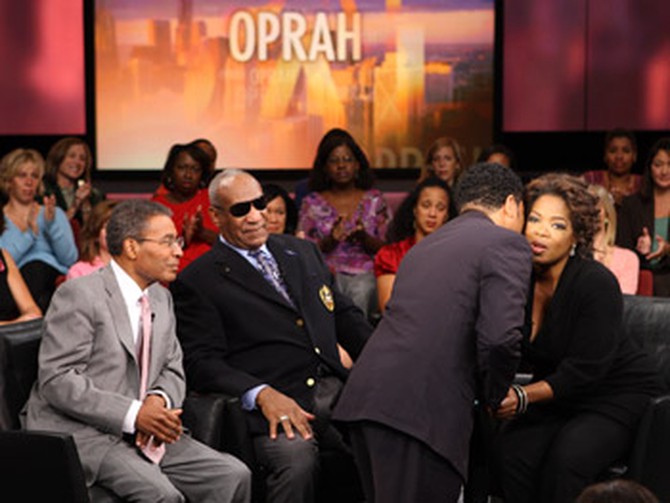 A show guest says hello to Oprah during taping.