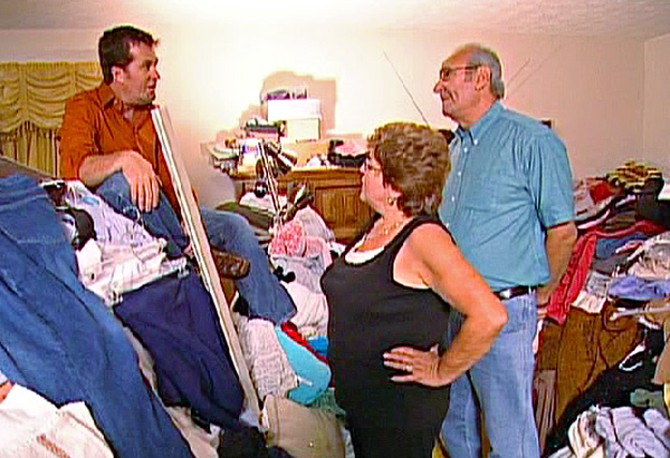 Peter, Sharyn and Marvin tackle the piles in the master bedroom.