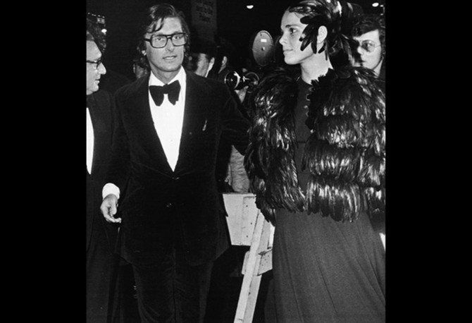 Ali MacGraw wearing a feathered cape at The Godfather premiere