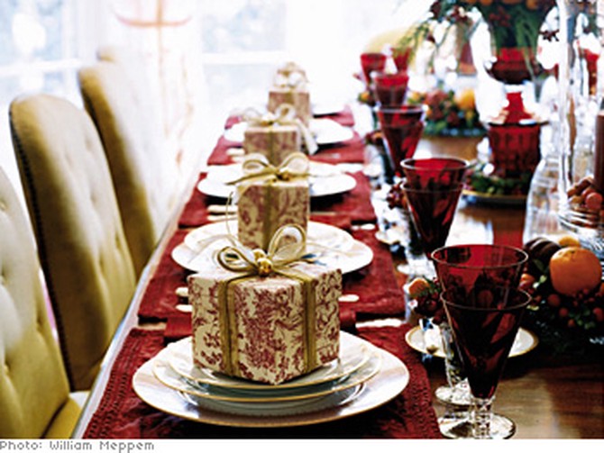 table set with goblets, candles, and presents