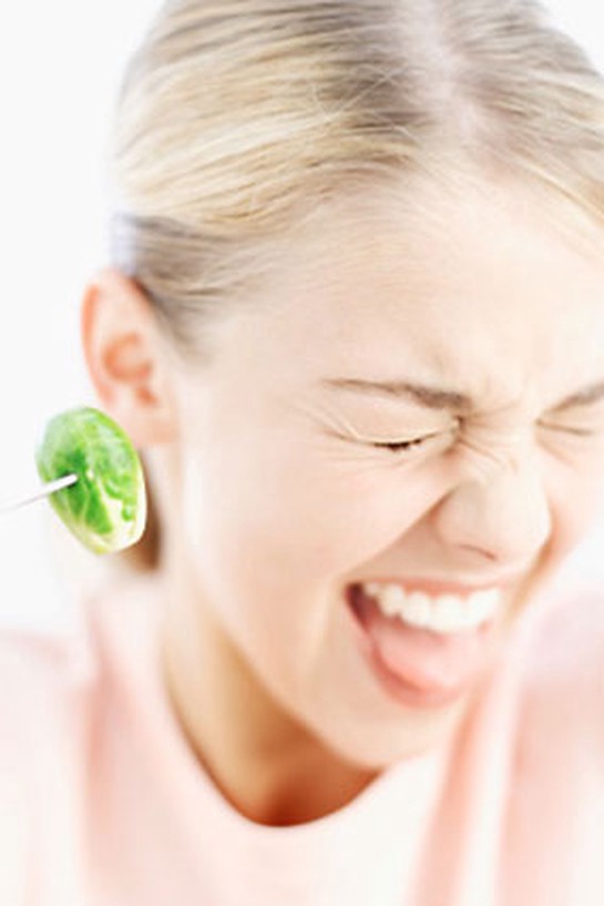 Woman eating a Brussels sprout