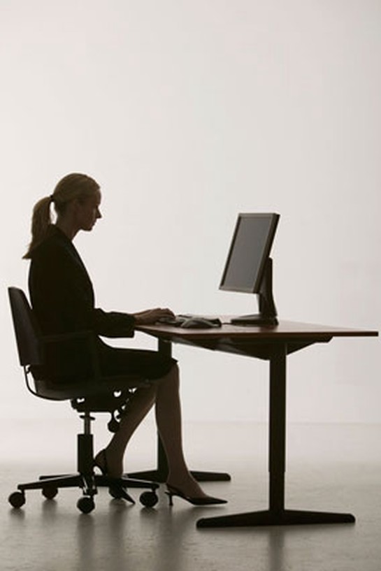 Woman sitting at desk sihouette