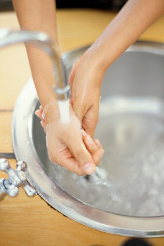 Woman washing her hands at the sink