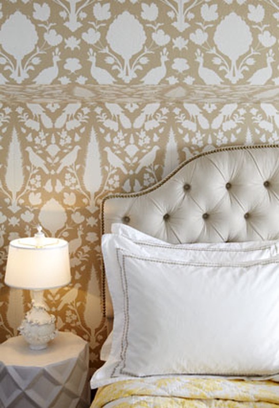 gold and white wallpaper with white headboard