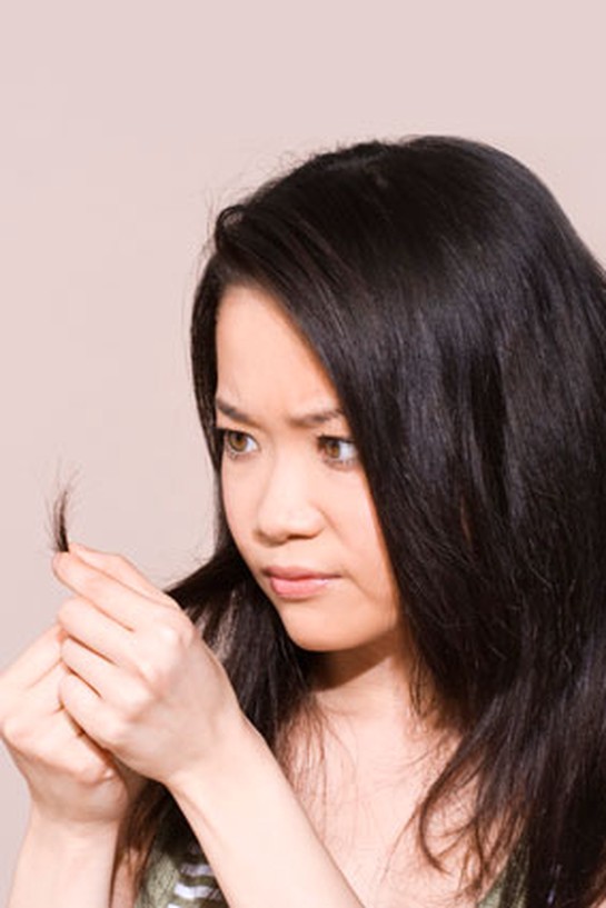 Woman examining her split ends