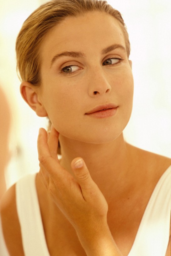 Woman applying neck cream