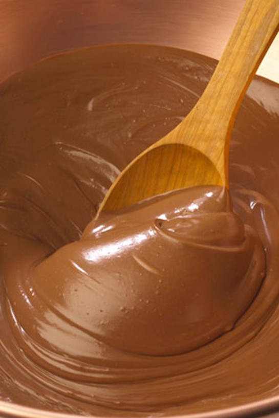 Wooden spoon stirring chocolate