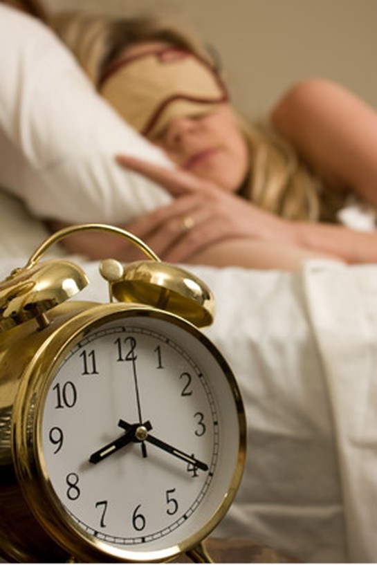 Sleeping woman with alarm clock