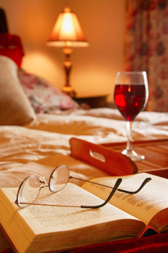 A glass of wine on the nightstand