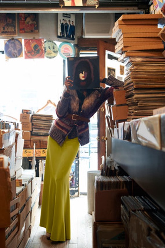 woman looking at a record wearing a maxi skirt