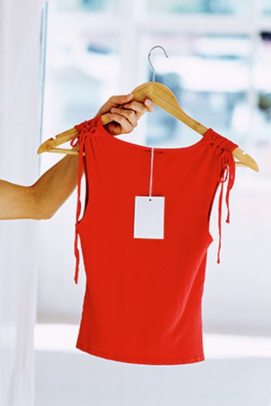 Red sleeveless shirt on wooden hanger