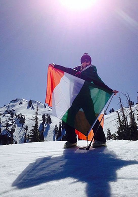 "Oprah & Eckhart Tolle: A New Earth" Chapter 6 guest Danielle McCormick holding Irish flag on snowy mountaintop
