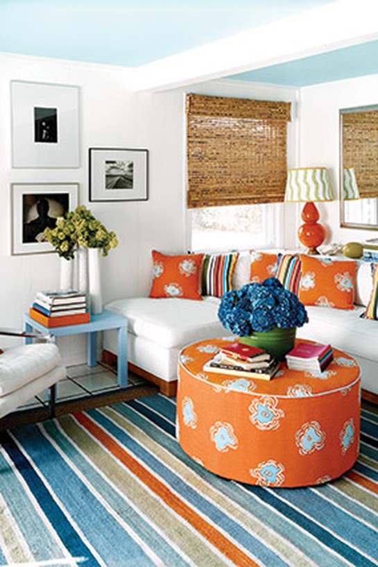 Blue-and-white living room with orange accents