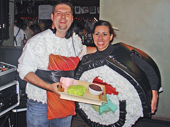 Estela and her husband dressed as sushi rolls.