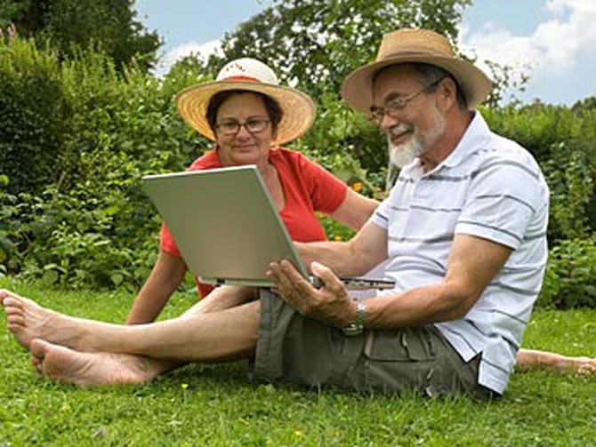 Couple in the garden with a laptop