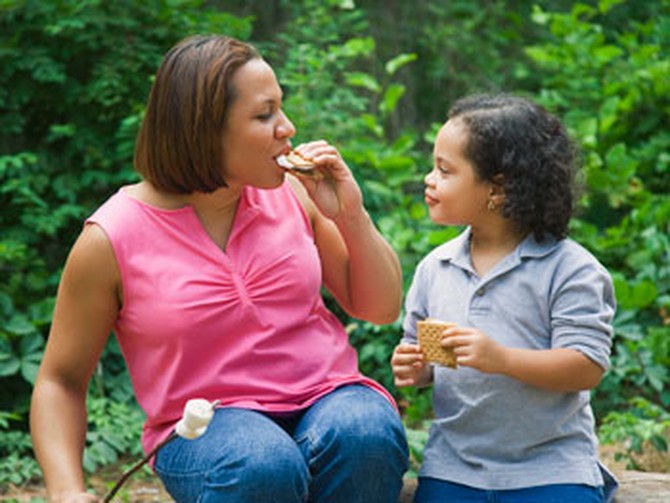 Mother and daughter eating smores