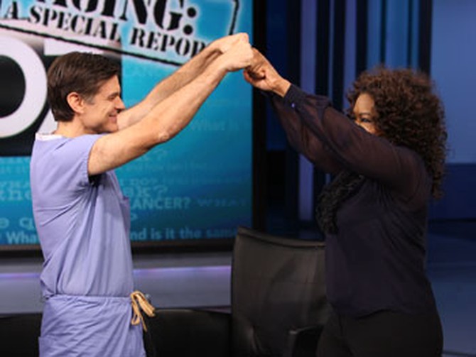 Dr. Oz and Oprah bump fists.