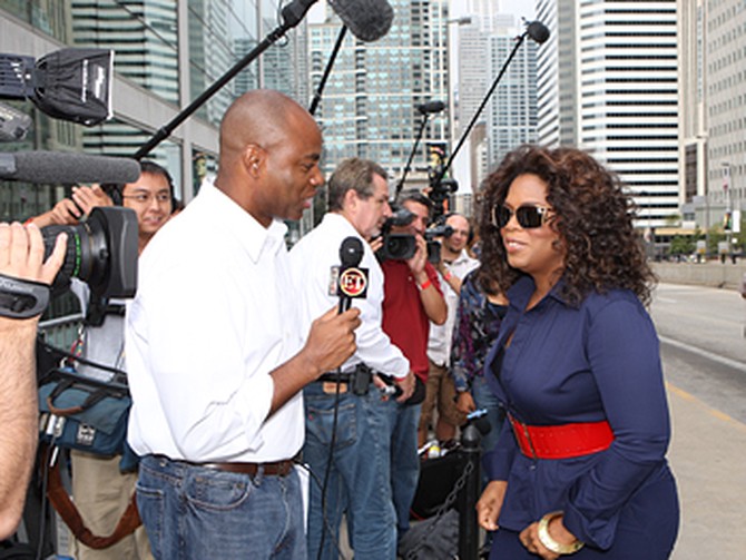 Oprah talks to a reporter.