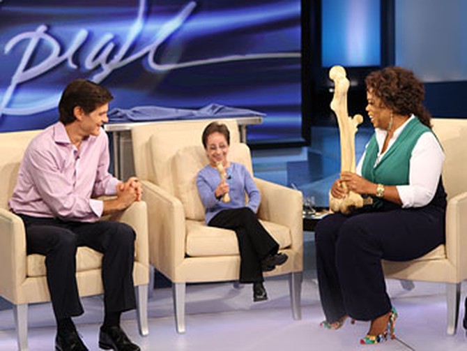 Dr. Oz show's Kristin a replica of her small femur, while Oprah holds a relica of Brenden's large femur.
