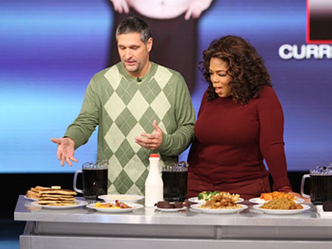 Roger Shultz shows Oprah his old diet.
