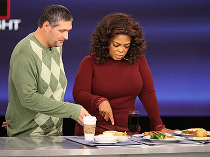 Roger Shultz shows Oprah his new diet.