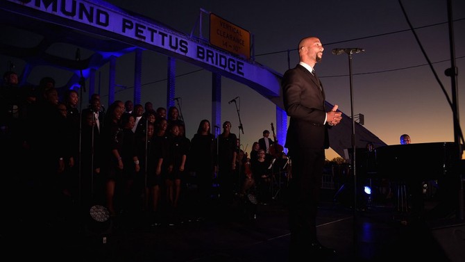 Common performing in front of the Edmund Pettus Bridge