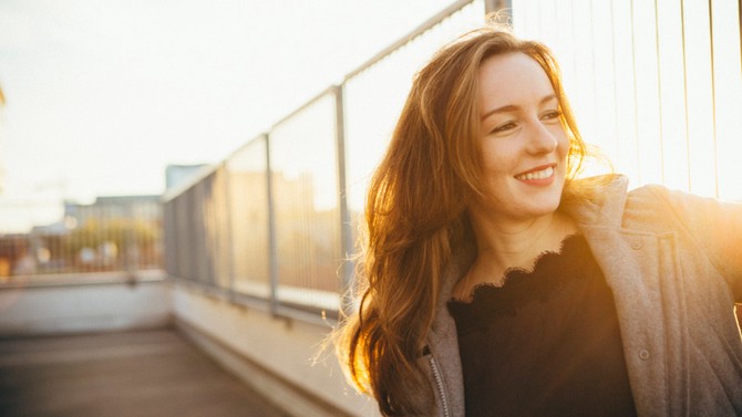 woman smiling at sunset